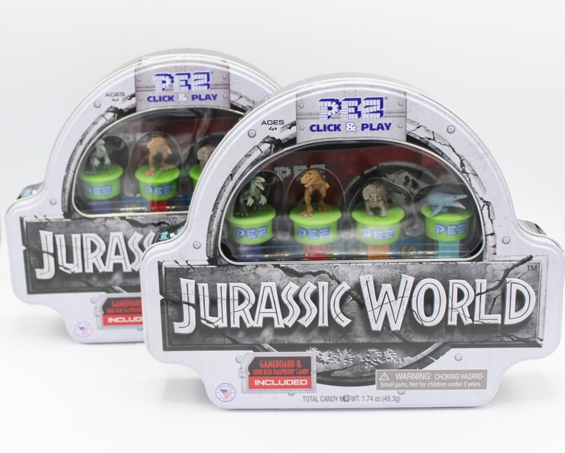 JURASSIC WORLD PEZ CLICK & PLAY SETS: TWO IN LOT, NEVER OPENED, MINT. GAMEBOARD & SOUR BLUE RASPBERRY CANDY INCLUDED. ESTIMATE:$25-$50