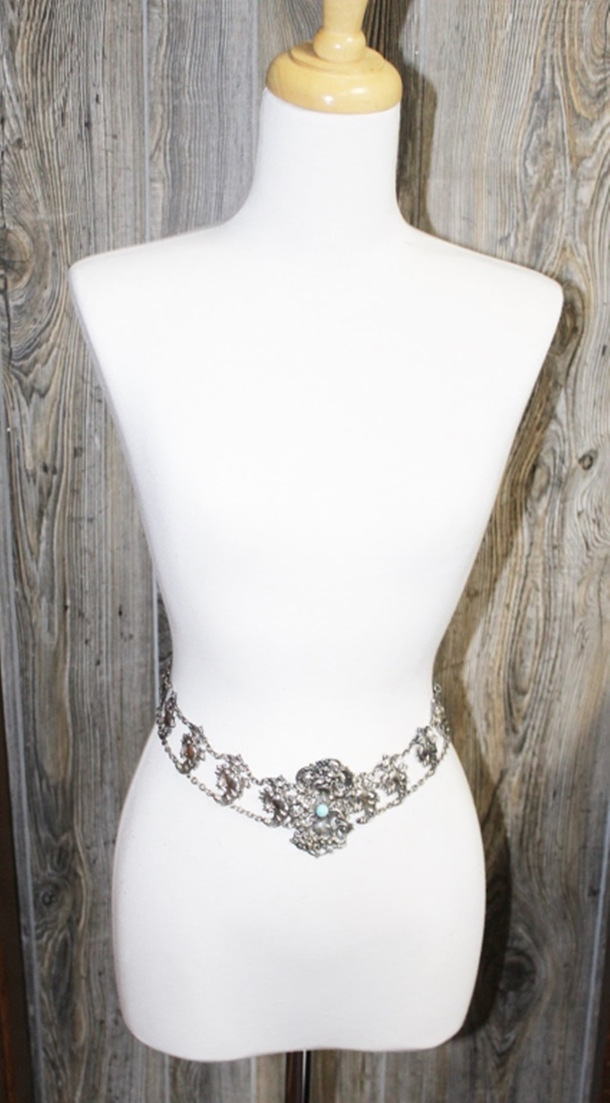 VINTAGE SILVER-TONED BELT: WITH TURQOISE LIKE STONES. 25 1/2" LONG. BUCKLE IS 2" X 3". ESTIMATE: $25-$50