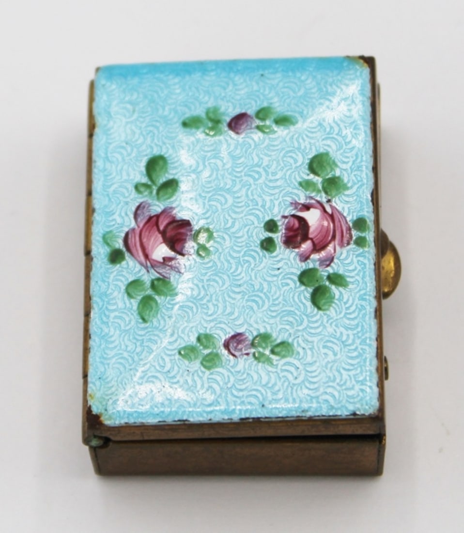 VINTAGE PILL BOX: GOLD TONED WITH HAND PAINTED FLORAL DESIGN. 1" X 1 1/2". ESTIMATE: $1-$50