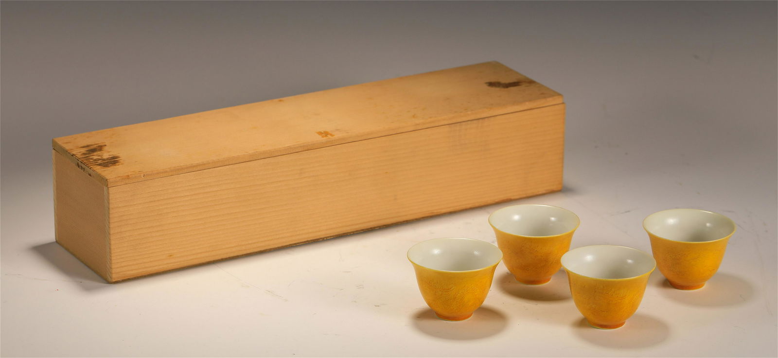 A GROUP OF FOUR YELLOW GLAZED CUPS (1 of 7)