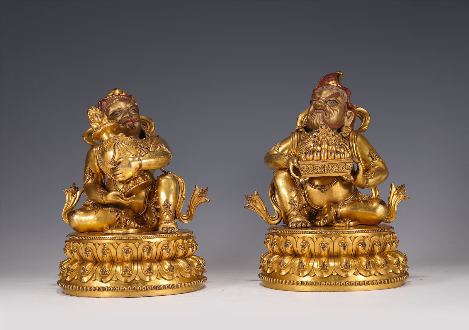 A PAIR OF GILT-BRONZE SEATED GUARDIANS (1 of 8)