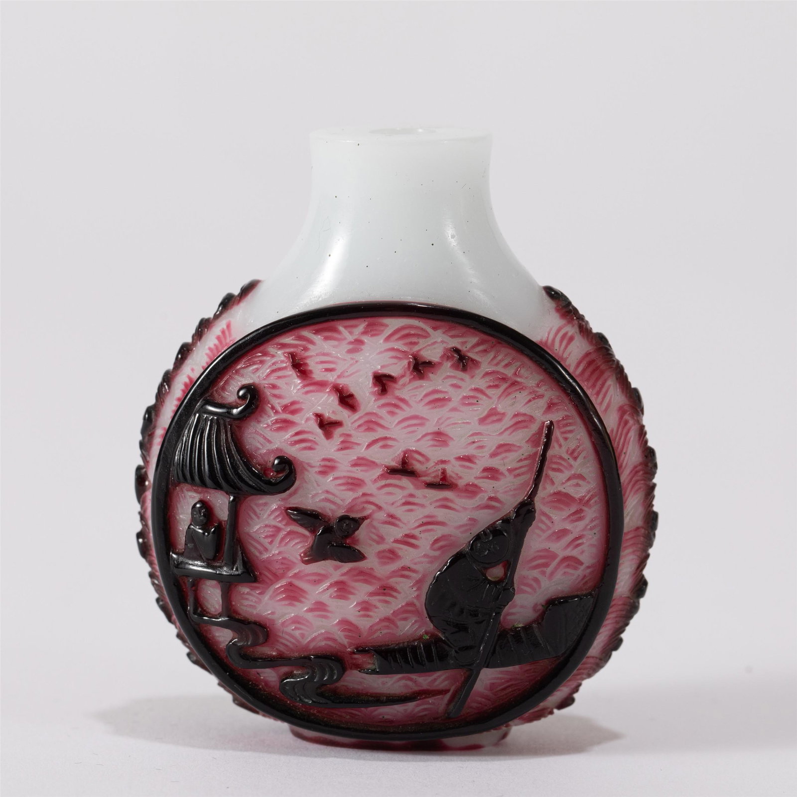 A CHINESE PEKING GLASS SNUFF BOTTLE: A CHINESE PEKING GLASS SNUFF BOTTLE The snuff bottle, carved figures boating along river at the exterior, against milky ground. Dimension: L. 5.5 cm. W. 3 cm. H. 6.2 cm. Weight 50 grams.