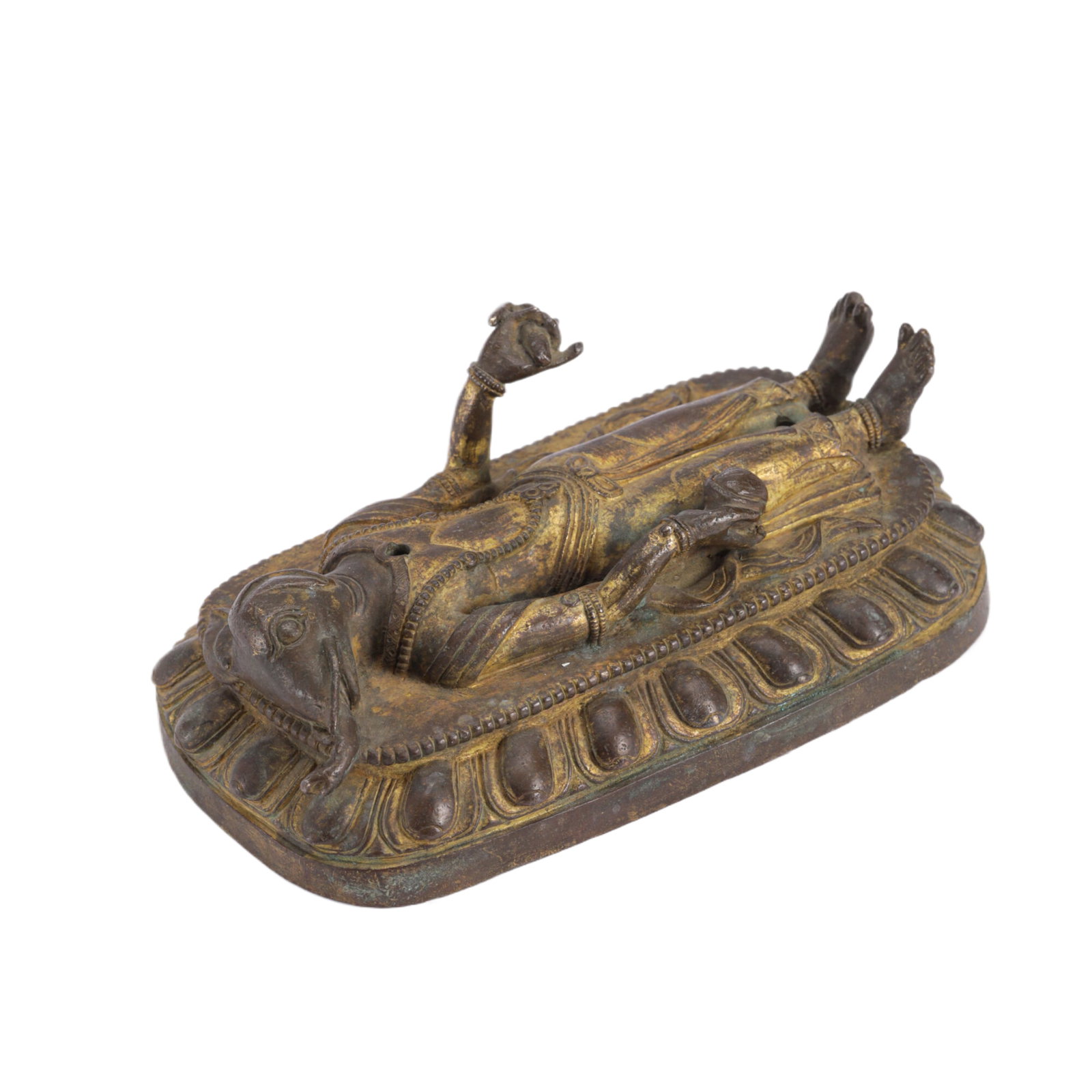 A SINO-TIBETAN BRONZE GILT STAND: A SINO-TIBETAN BRONZE GILT STAND The prostrate figure of Ganesha, best known as a Hindu god, but in this context represents the delusion and worldly attachments that must be overcome to realize one’