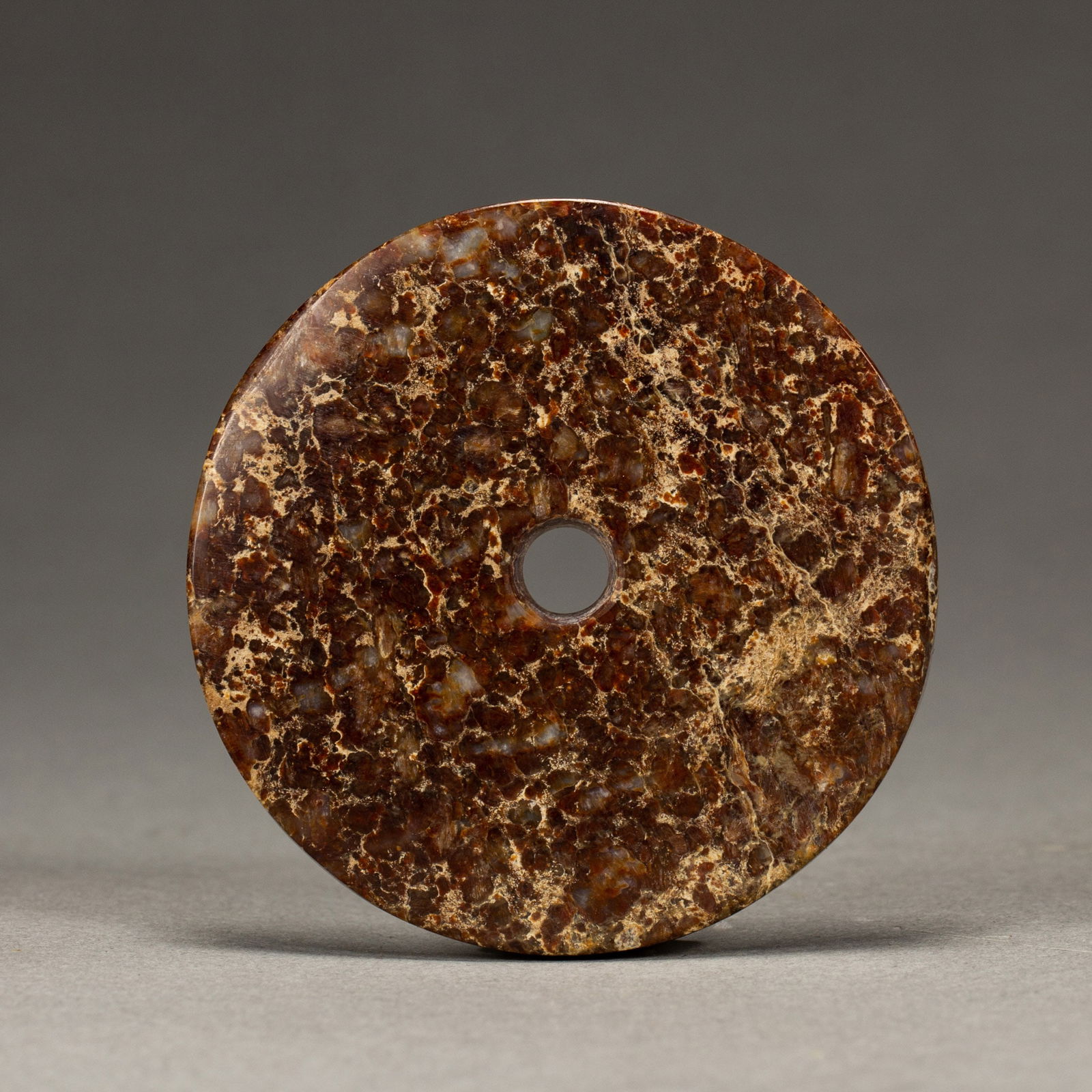 A CHINESE REDDISH-BROWN JADE BI DISC (1 of 9)