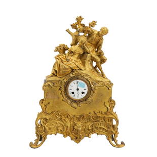 A FRENCH ORMOLU GILT-BRONZE MANTLE CLOCK: A FRENCH ORMOLU GILT-BRONZE MANTLE CLOCK Surmounted with love couples, on a pierced rocaille base, richly gilt. Dimension: L. 37.5 cm. W. 10.5 cm. H. 51 cm.