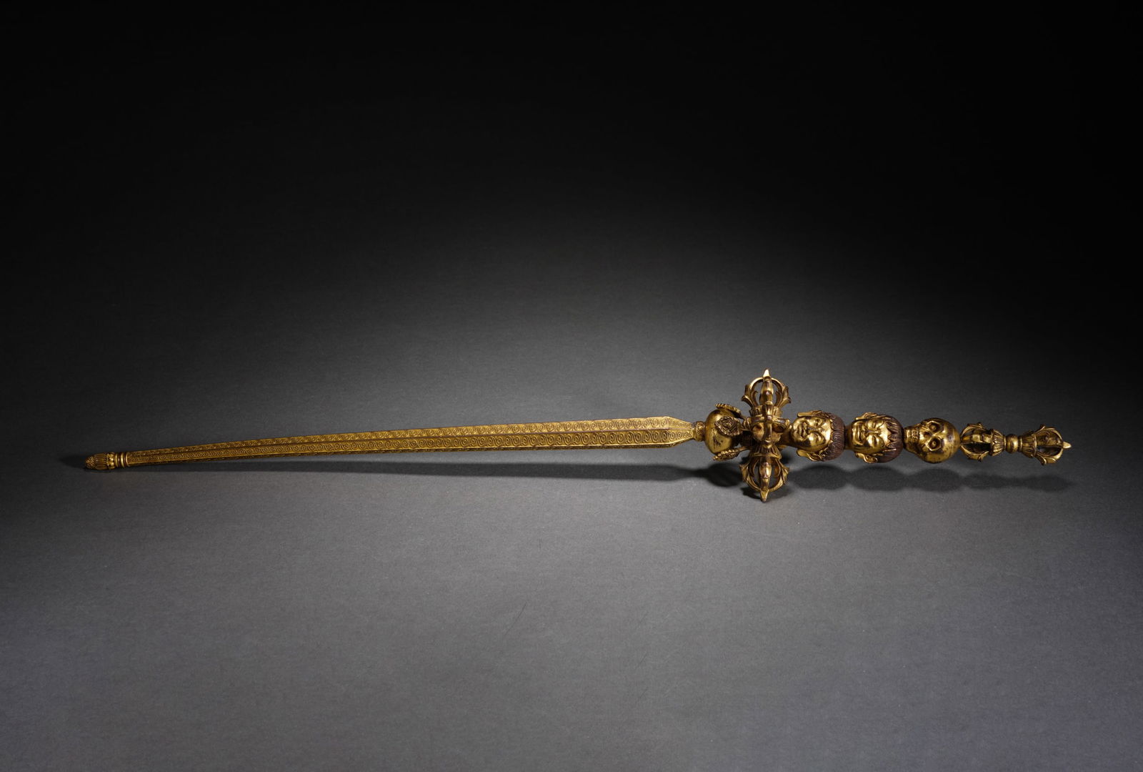 A TIBETAN BRONZE-GILT KHATVANGA (1 of 8)