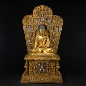 A VERY RARE BRONZE-GILT SEATED SHAKYAMUNI
