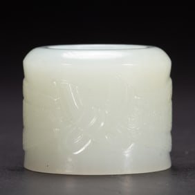 A CARVED WHITE JADE ARCHER RING