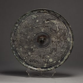 A BRONZE CIRCULAR MIRROR