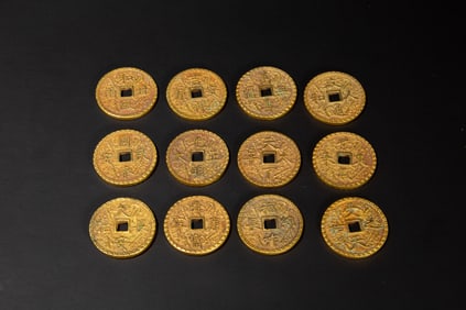 A COLLECTION OF BRONZE-GILT COINS