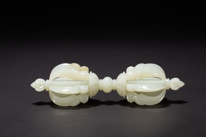 A CARVED WHITE JADE VAJRA