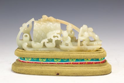 A CARVED WHITE JADE BOAT