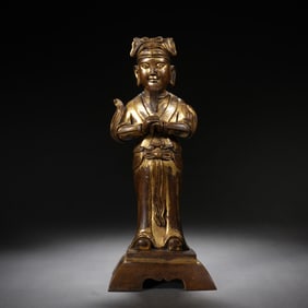 A BRONZE-GILT STANDING GUANPING