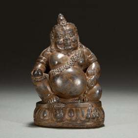 A CARVED STONE SEATED JAMBHALA