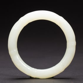 A CARVED WHITE JADE BANGEL