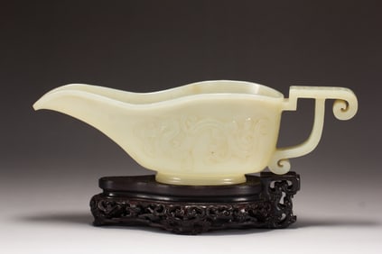 A CARVED WHITE JADE POURING VESSEL