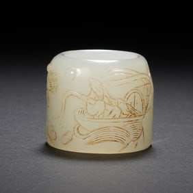 A CARVED WHITE JADE ARCHER RING
