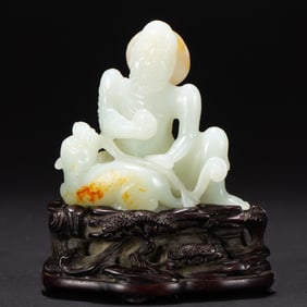 A CARVED WHITE JADE LUOHAN