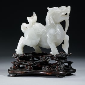 A CARVED WHITE JADE KYLIN