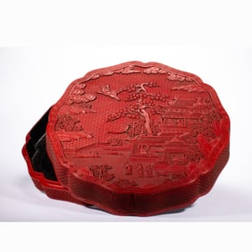 A CARVED CINNABAR LACQUER BOX WITH COVER