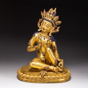 A BRONZE-GILT SEATED DEITY