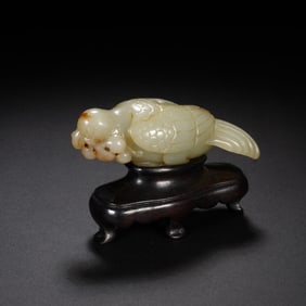 A CARVED WHITE JADE BIRD