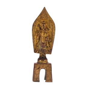 A BRONZE-GILT STANDING BUDDHA