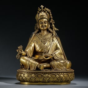 A BRONZE-GILT SEATED PADMASAMBHAVA