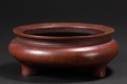 A BRONZE TRIPOD CENSER