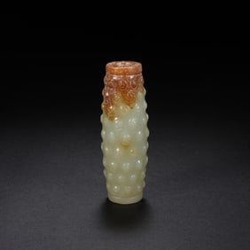 A CARVED JADE BEAD