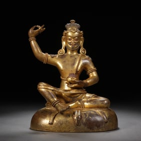 A TIBETAN BRONZE-GILT SEATED SIDDHA