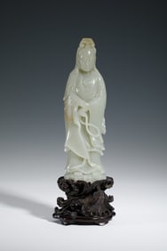 A CARVED WHITE JADE STANDING GUANYIN