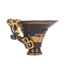 A BRONZE PARTLY-GILT LIBATION CUP