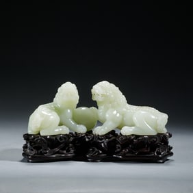 A CARVED WHITE JADE LIONS GROUP