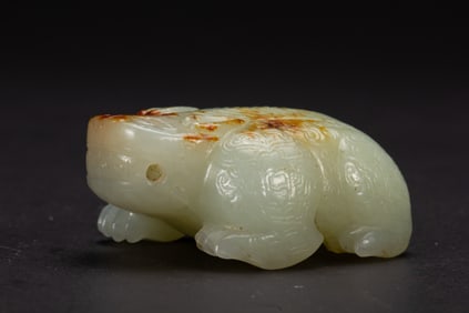 A CARVED WHITE JADE MYTHICAL BEAST