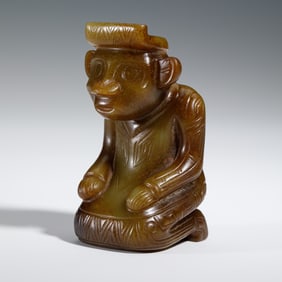 A CARVED JADE KNEELING FIGURE