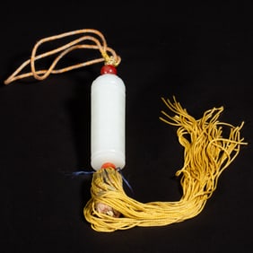 A CARVED WHITE JADE SUTRA PENDANT