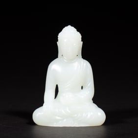 A CARVED WHITE JADE SEATED BUDDHA