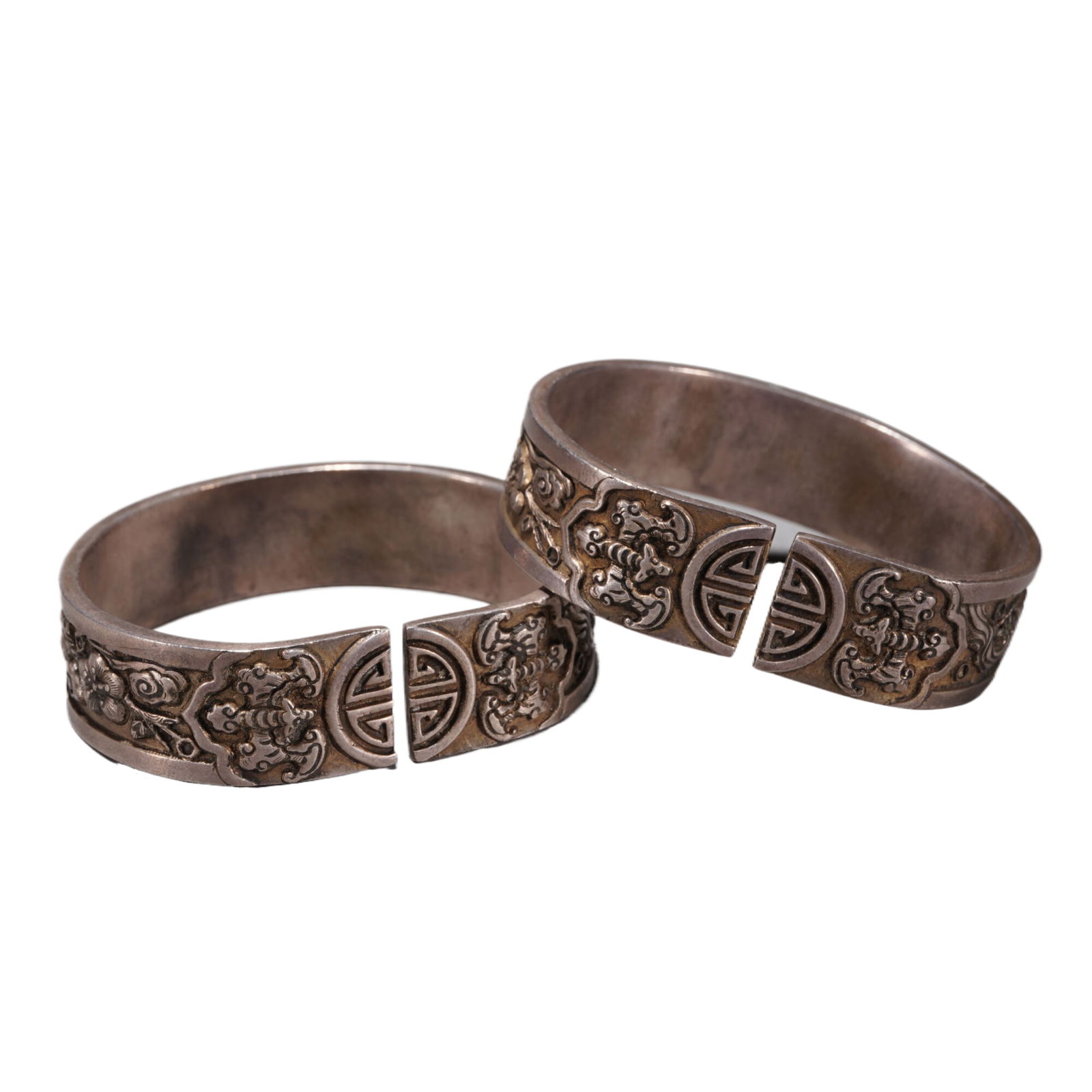 PAIR SILVER BANGLES: PAIR SILVER BANGLES Decorated with auspicious symbols at the surface, with oxidize marks. Dimension: 6.5x5.5x1.7 cm. Weight 162 grams.