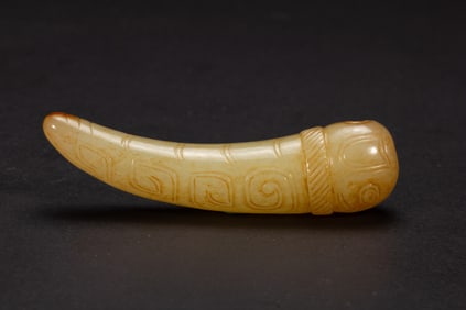 A CARVED JADE SILK WORM-SHAPED PENDANT