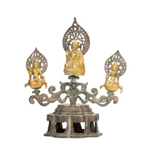 A BRONZE-GILT VOTIVE FIGURE OF BUDDHA