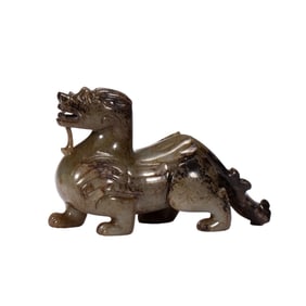 A RARE CARVED JADE MYTHICAL BEAST BIXIU
