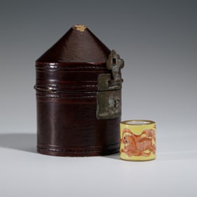 AN IRON RED AND GILT ARCHER RING
