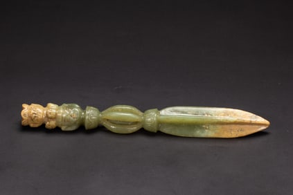 A CARVED CELADON JADE PHURBA