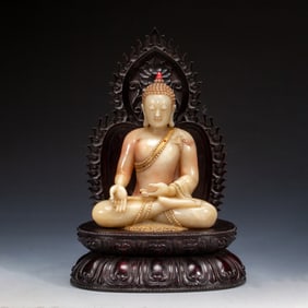 A CARVED SHOUSHAN STONE SEATED BUDDHA