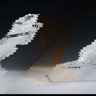 A CARVED ROCK CRYSTAL MYTHICAL BEAST DECORATION: A CARVED ROCK CRYSTAL MYTHICAL BEAST DECORATION The recumbent beast seated, with back legs tucked beneath the muscular body, front left hand raised, its head turned to the right side. Dimension: L. 12