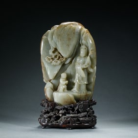 A CARVED JADE GUANYIN BOULDER