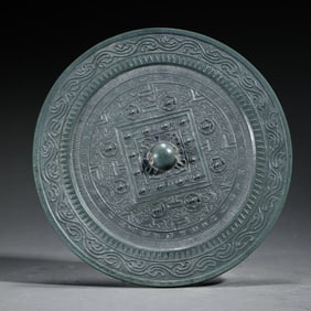 A BRONZE CIRCULAR MIRROR