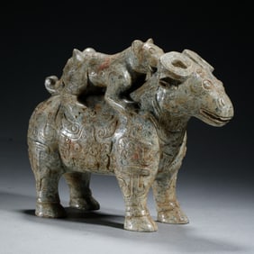 AN ARCHAISTIC CARVED JADE RAM