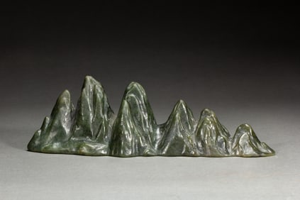 A CARVED SPINACH GREEN JADE BRUSHREST